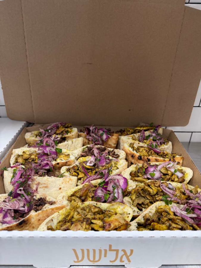 Catering box of chicken shawarma pita with pickled onion
